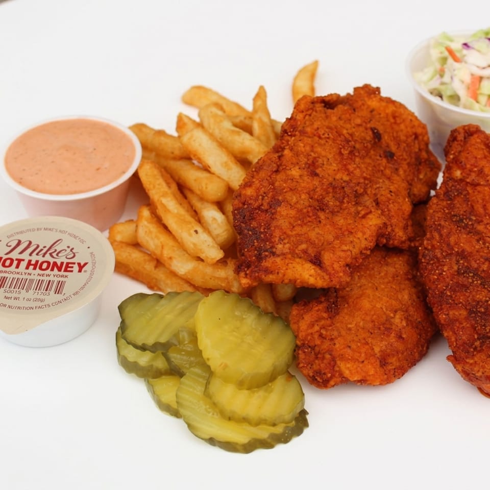 Crispy fried chicken tenders, crinkle-cut fries, pickles, coleslaw, and two dipping sauces, including Mike's Hot Honey.